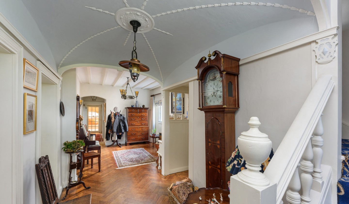 Hall way with parquet flooring